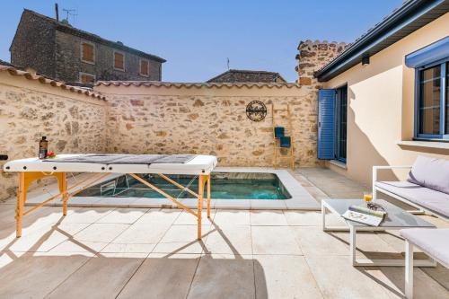 a pool in the backyard of a house at Le Patio d'Arlou & Spa - Relaxant et romantique in Fabrezan