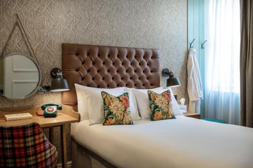a bedroom with a large bed and a mirror at Middletons in York