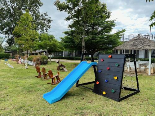 a playground with a blue slide in a yard at 4 Corner Khaoyai in Mu Si