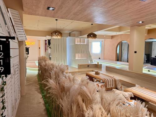 a living room with couches and plants in a building at perBed Hostel-Taichung Station in Taichung