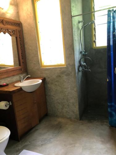 a bathroom with a sink and a shower at Limericks by the Sea in Savusavu