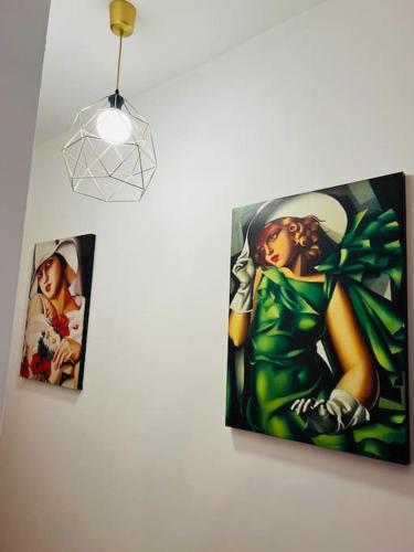 two pictures hanging on a wall next to a light fixture at Aniene Home Roma in Rome