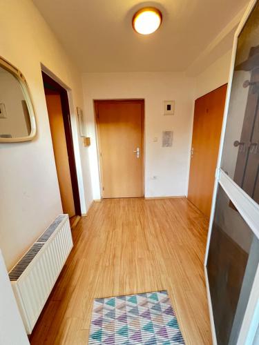 a hallway of an apartment with wooden floors and doors at Ubytování Sýkora Apartments in Veľký Meder