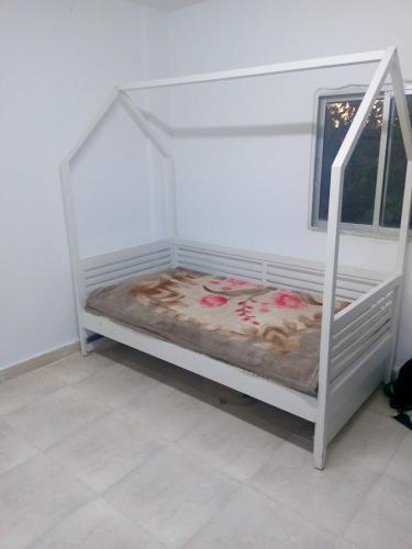 Litera blanca en habitación con ventana en الكرك - الربة, 