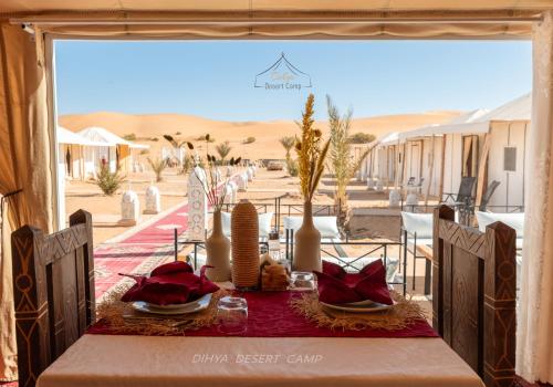 a table in the desert with a view of the desert at Dihya desert camp in Merzouga
