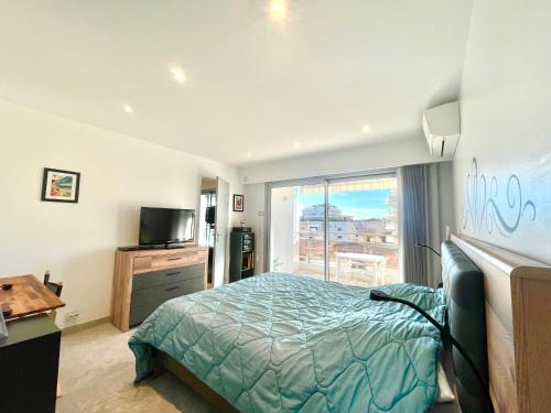 a bedroom with a bed and a large window at Maryline by Welcome to Cannes in Cannes