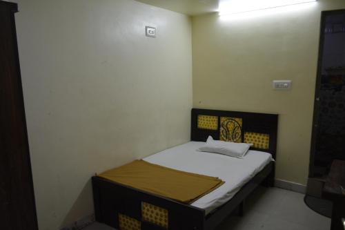 een kleine slaapkamer met een bed in een kamer bij Hotel Garden Residency By WB Inn in Bangalore