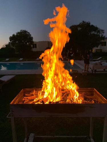 a large fire in a box with flames at Residence Altair - Serra degli Alimini in Otranto