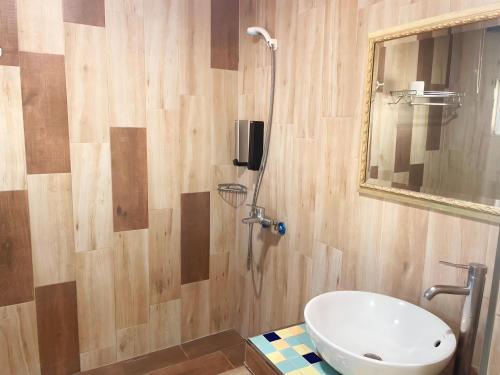 a bathroom with a toilet and a sink and a mirror at Kenting Garden Homestay in Kenting
