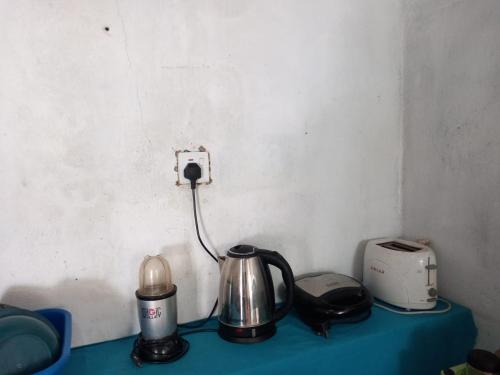 a counter top with a tea kettle and a toaster at The Madampa Sea Side Lodge in Ambalangoda