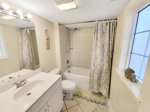 a bathroom with a sink and a toilet and a tub at Sunset Bay 409 in Ocean City