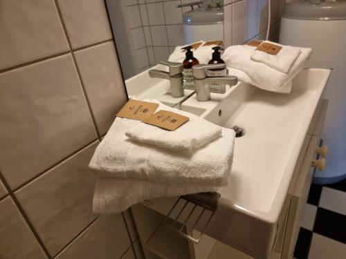 a bathroom with two towels on a sink at Kjellerleilighet egen inngang. in Stange