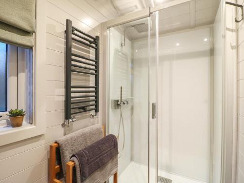 a bathroom with a shower with a glass door at Yes Deer in Ashbourne