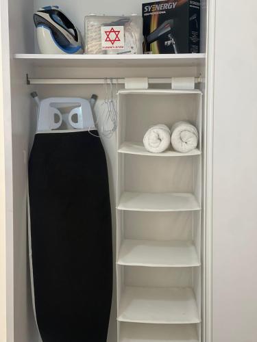 a refrigerator with its door open with its shelves at Emanuel Suite in Eilat