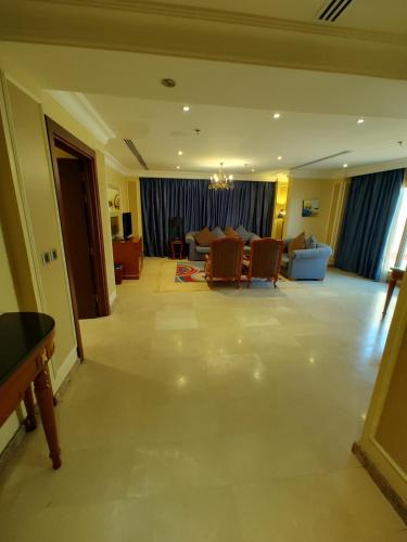 a living room with a couch and a table at فندق كارم العليا in Al Khobar