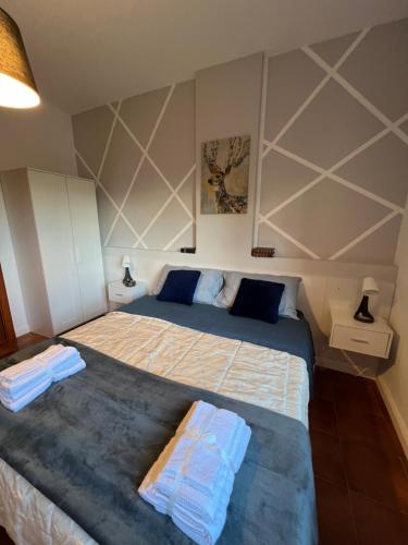 a bedroom with a bed with two towels on it at Aniene Home Roma in Rome