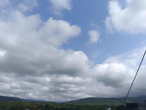 a cloudy sky with mountains in the background at Cambulos House in Melgar