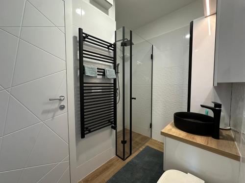 a bathroom with a toilet and a shower at Scamard Apartman in Zamárdi