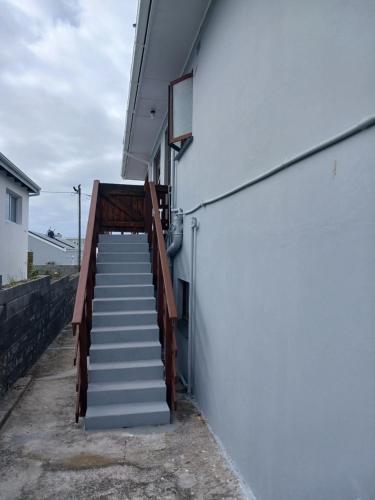 a stairway leading up to a white building at Vergezicht Upper Unit in Franskraal