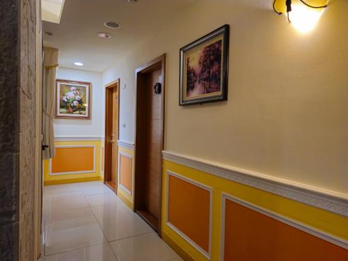 a hallway of a building with a painting on the wall at Kenting Garden Homestay in Kenting