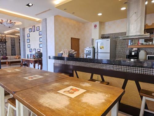 a kitchen with two tables and a counter top at Kenting Garden Homestay in Kenting