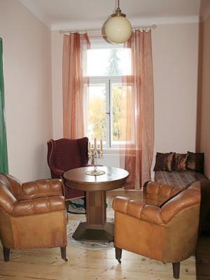 a living room with a table and two chairs at Edinburgh in Mariánské Lázně