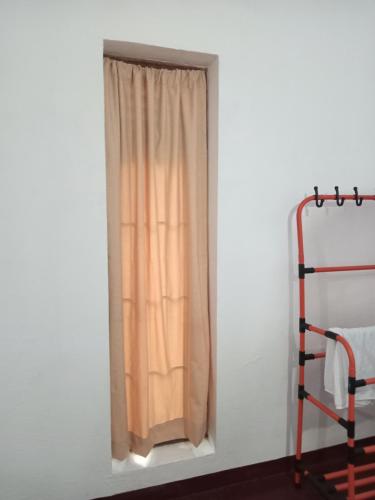 a window in a white room with a curtain at Villa 147 in Hikkaduwa