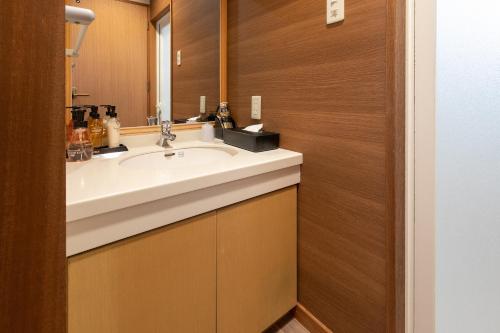 a bathroom with a sink and a mirror at Ocean Resort Nomon長崎 in Nomo