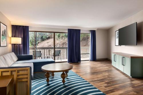 a living room with a couch and a table at Hilton Garden Inn Monterey in Monterey
