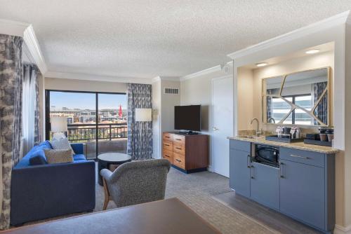 a living room with a kitchen and a living room with a view at Embassy Suites by Hilton Anaheim-Orange in Anaheim
