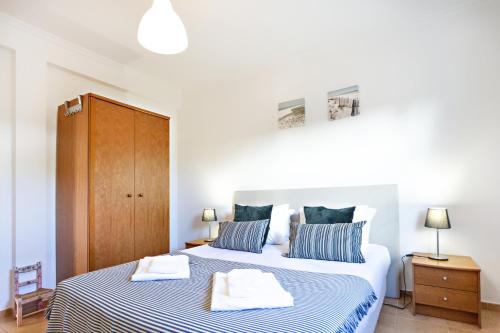 a bedroom with two beds with blue and white sheets at Casa Correia - Charming Holidays House in Vila Nova De Cacela