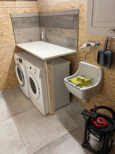 a laundry room with a washing machine and a sink at Chez Quiet, Chez Qalm, Chez Que4 in Durbuy