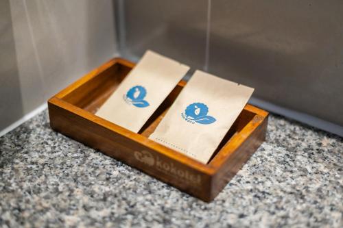 a wooden box sitting on a counter with two receipts at Kokotel Krabi Ao Nang in Ao Nang Beach