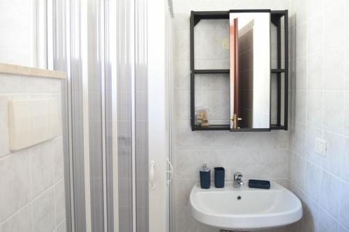 a white bathroom with a sink and a shower at Affittacamere Ellera Verde in Villetta Barrea