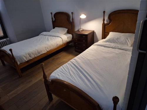 a bedroom with two beds and a table with a lamp at Casa bajo el acueducto con plaza de garaje in Segovia
