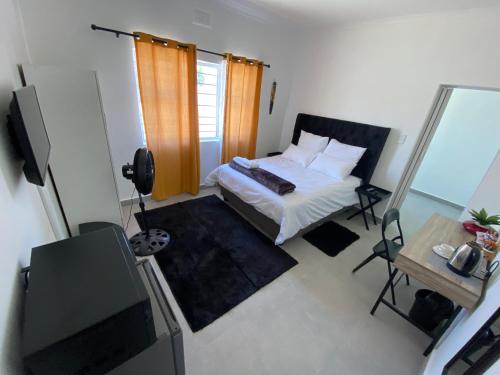 a bedroom with a bed and a tv in a room at No 1 Guest house in Cape Town