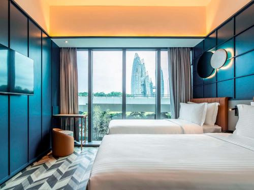 a hotel room with two beds and a large window at Hotel Faber Park Singapore - Handwritten Collection in Singapore