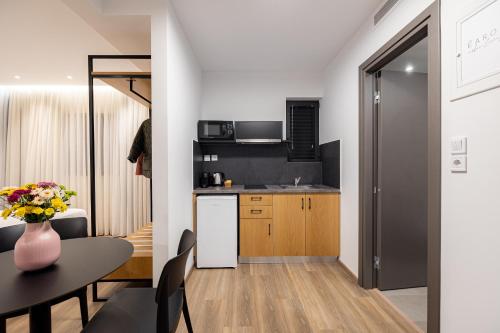 a kitchen and dining room with a table at Earos Urban Living in Athens