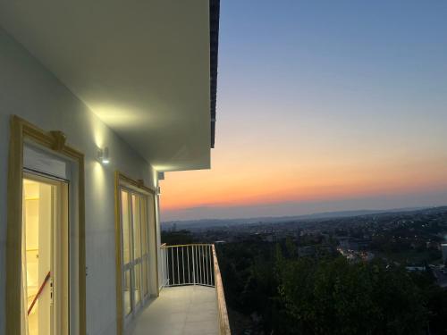 a balcony with a view of a sunset at Villa Pasha Tirane in Tirana