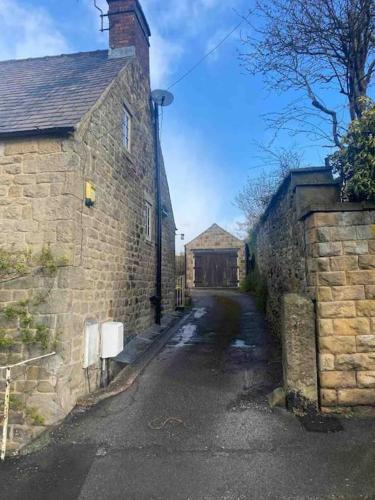 an empty street in an old stone building at Charming Coates Cottage in Baslow