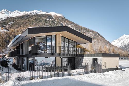 a house on top of a snow covered mountain at Chalet White Pearl by MYALPS in Sölden