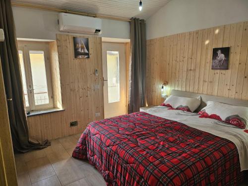 a bedroom with a bed with a red blanket at ROMEO2 in Somma Lombardo