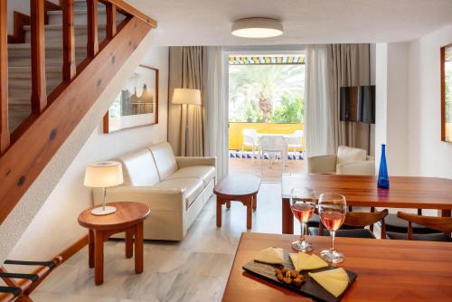 a living room with a couch and a table at Parque Santiago III Official in Playa de las Americas