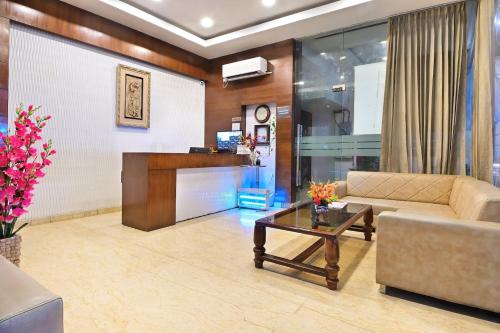 a living room with a couch and a table at hotel goodluck airport in New Delhi