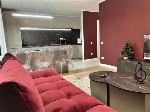 a living room with a red couch and a kitchen at STUDIO 92- URBAN PLAZA in Braşov