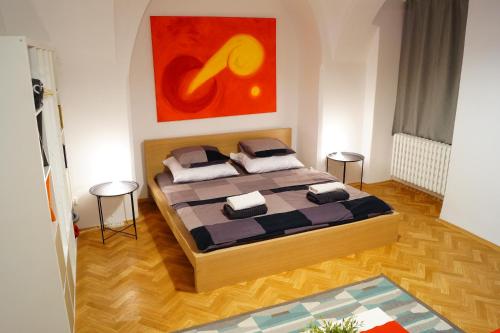 a bedroom with two beds and a painting on the wall at U Koniáše in Litoměřice