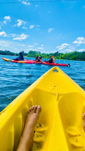 a persons feet in a yellow boat in the water at Lotus cool hotel and restaurant in Ibbagomuwa
