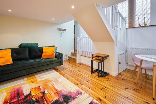 a living room with a couch and a table at Host & Stay - Millers Coach House in Hexham