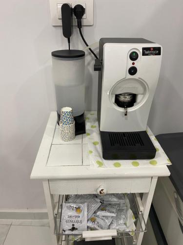 a white counter with a coffee maker on it at Isla Home in Naples