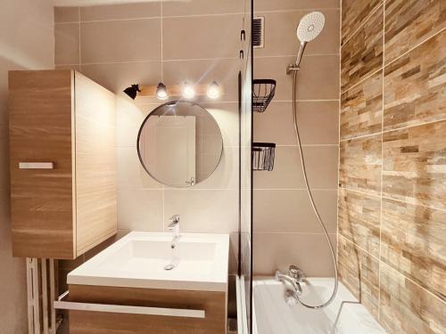 a bathroom with a sink and a shower and a mirror at Le Scarron - centre ville - garage privé - 4pers in Le Mans